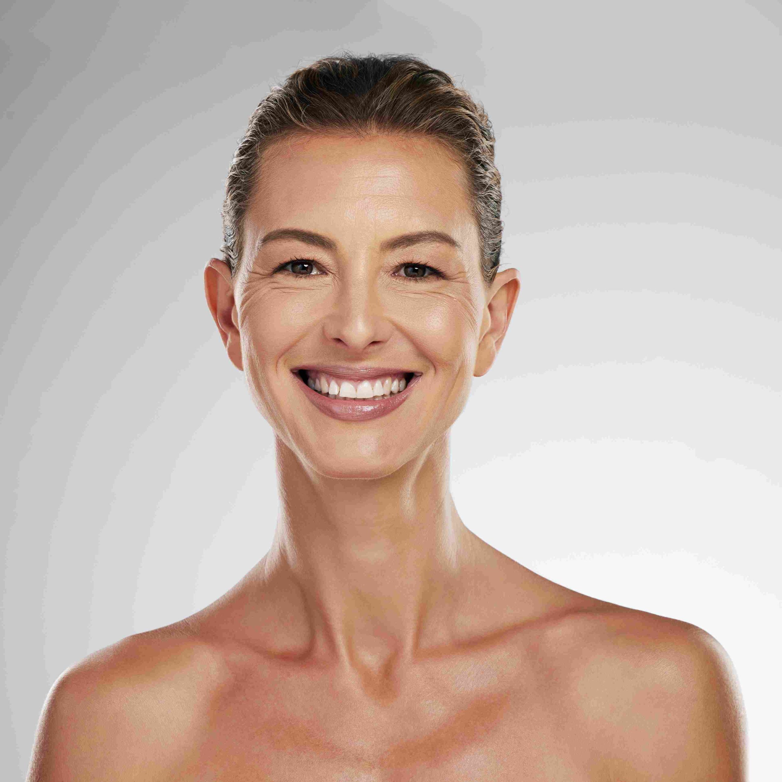 Portrait of a middle-aged lady smiling | Facial Volume Loss | Avail Aesthetics in Cary, Raleigh & Wake Forest, NC