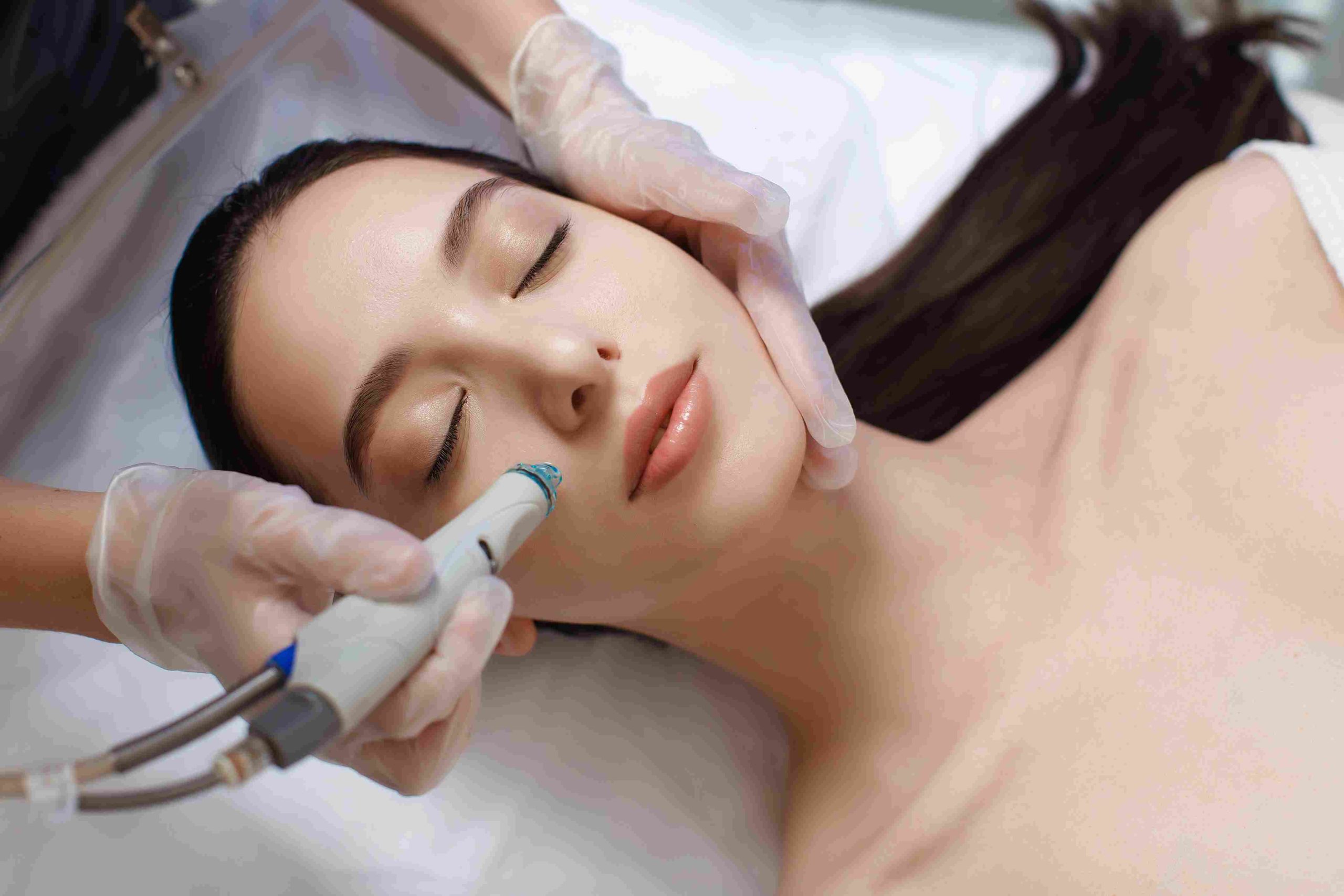 A Woman getting HydraFacials by a device | Avail Aesthetics in Cary, Raleigh & Wake Forest, NC