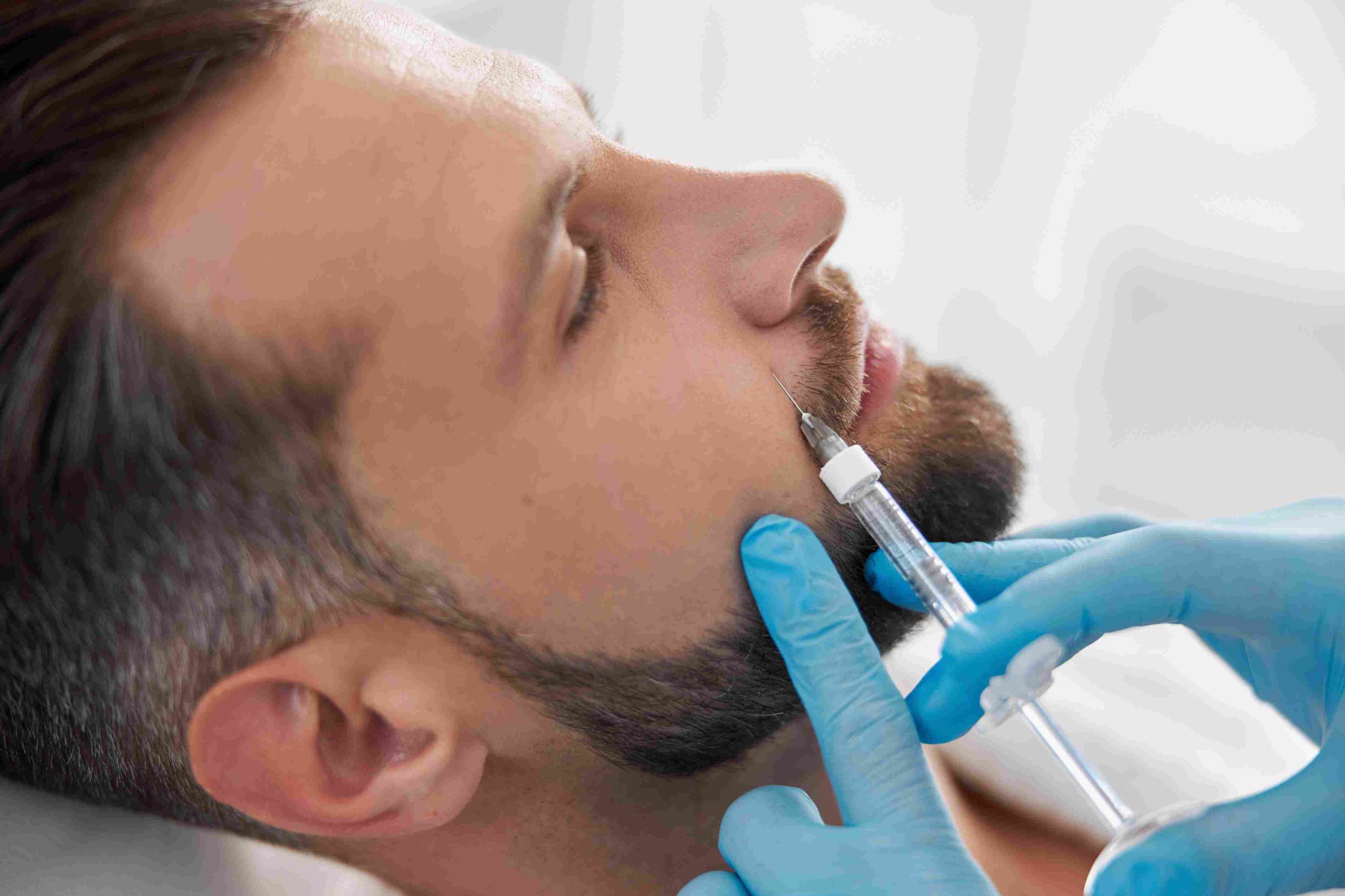 Portrait of a man getting injection on face | Revanesse Versa | Avail Aesthetics in Cary, Raleigh & Wake Forest, NC
