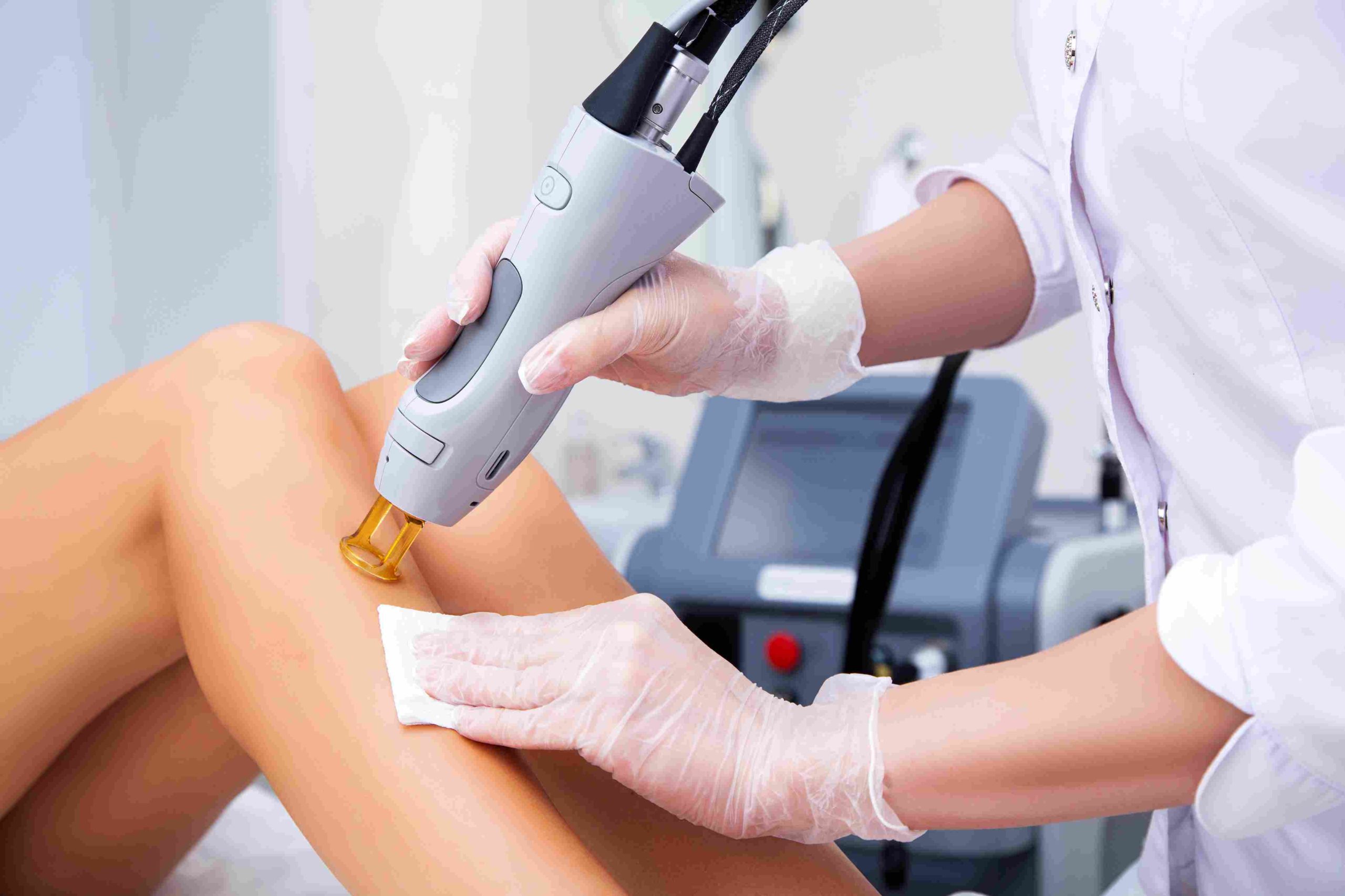 Portrait of a woman getting treatment on legs by a device | Elite Iq | Avail Aesthetics in Cary, Raleigh & Wake Forest, NC