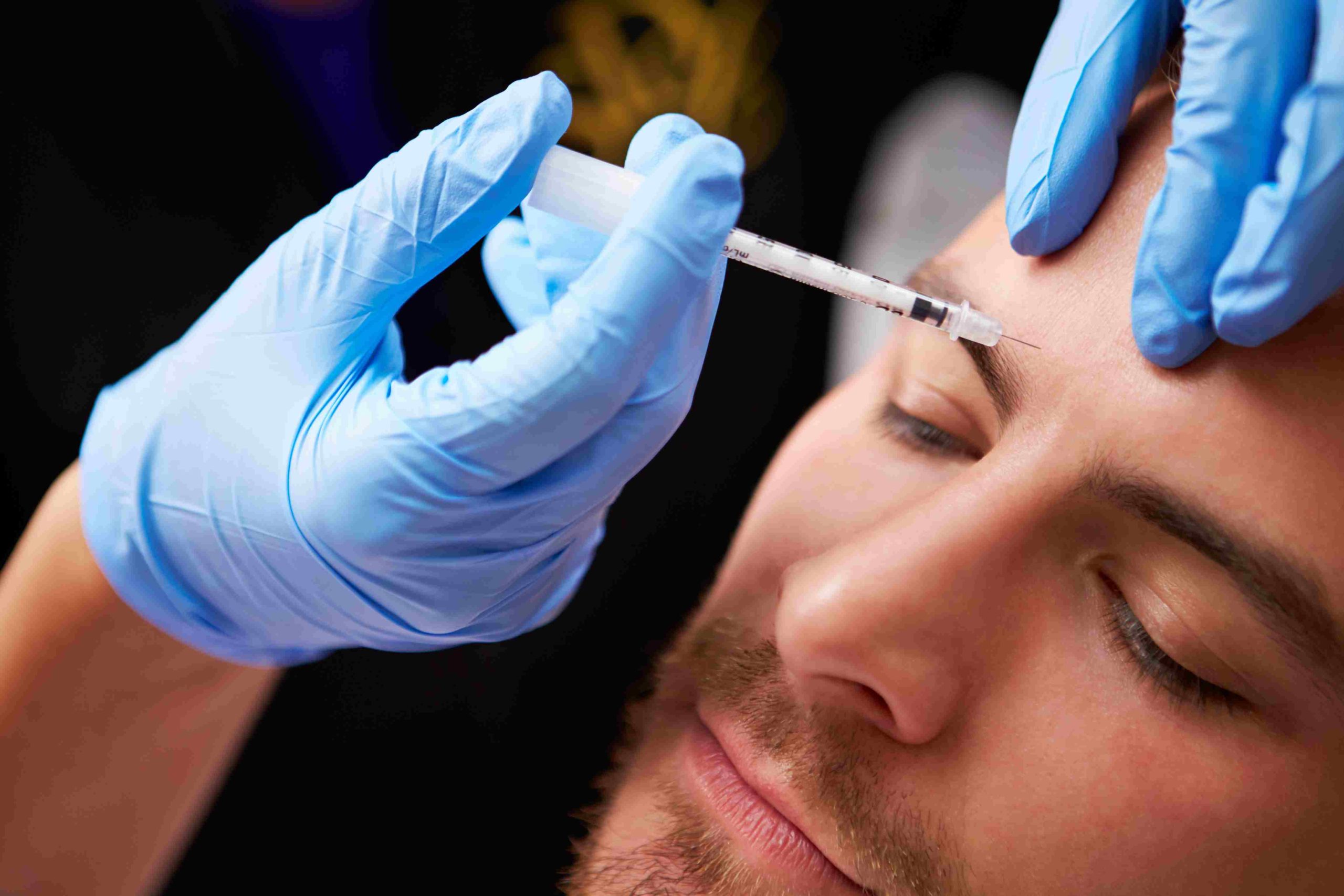 Handsome man getting Botox cosmetic Injection on forehead | Avail Aesthetics in Raleigh, NC
