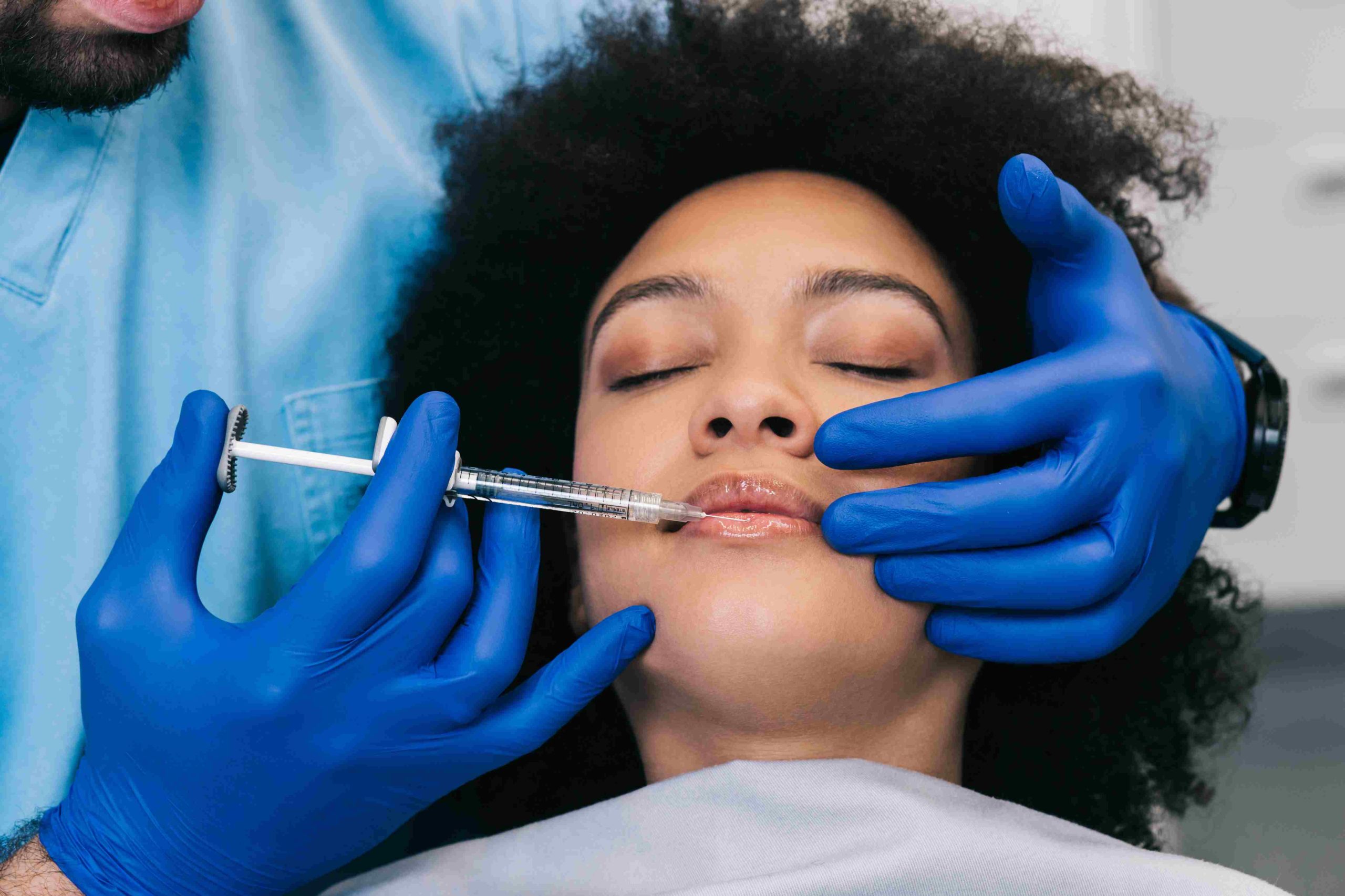 African Woman Receiving Lip Filler Injection | Avail Aesthetics in Cary, NC