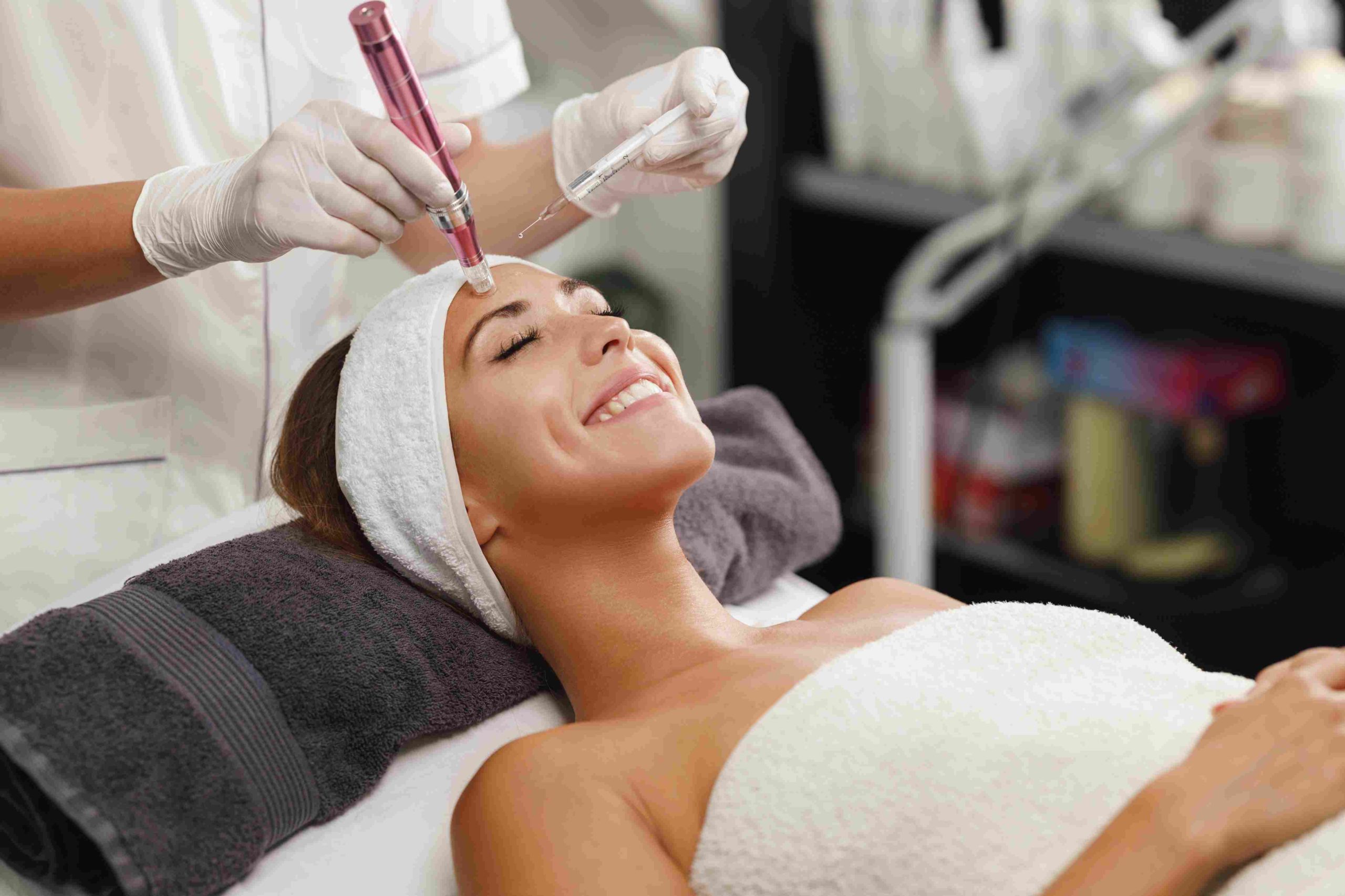 Lying Dimpled Smiling Woman Getting RF Microneedling Treatment | Avail Aesthetics in Cary, NC