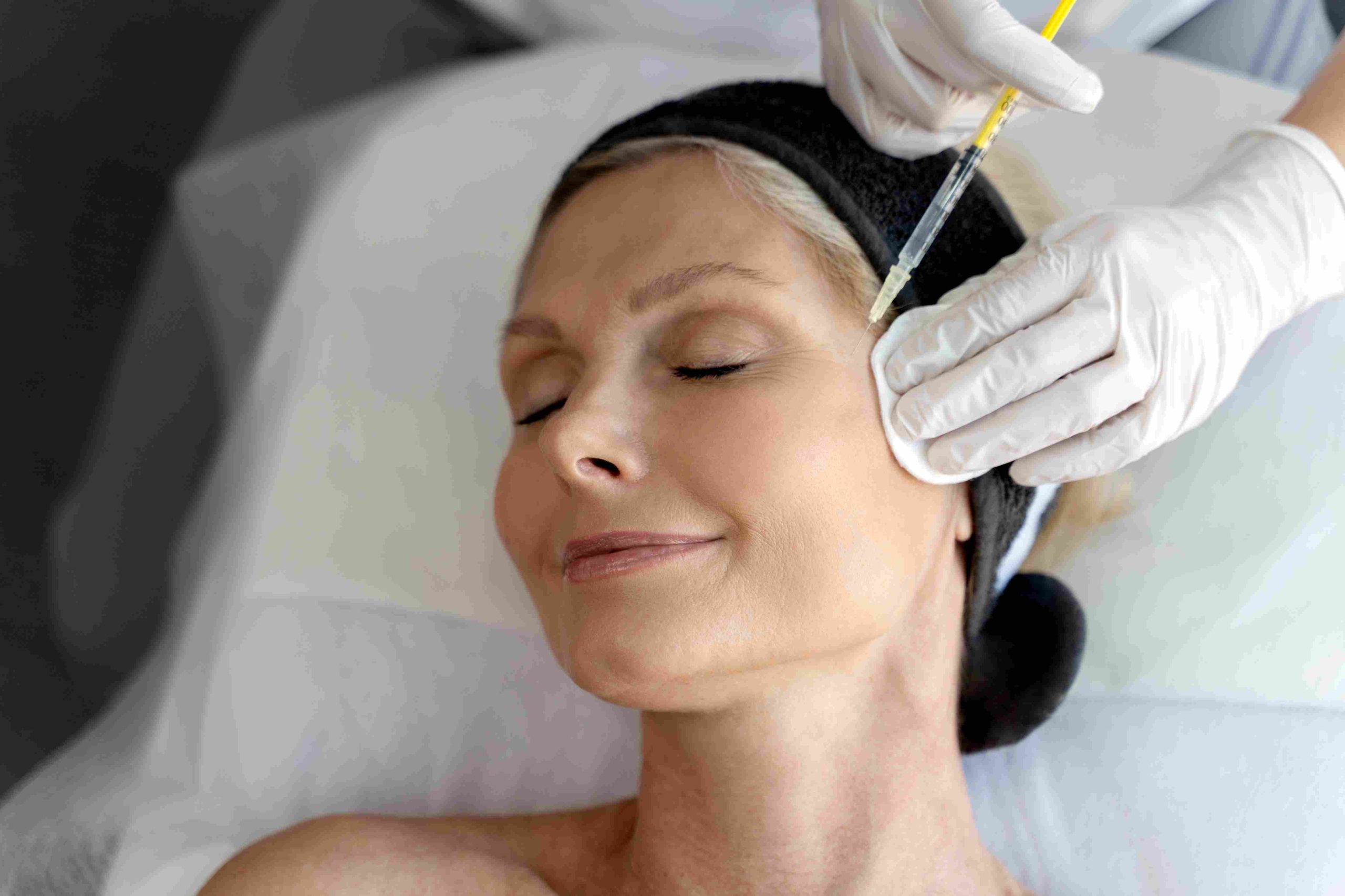 Woman Getting Radiesse Injection on Temporal Area | Avail Aesthetics in Raleigh, NC
