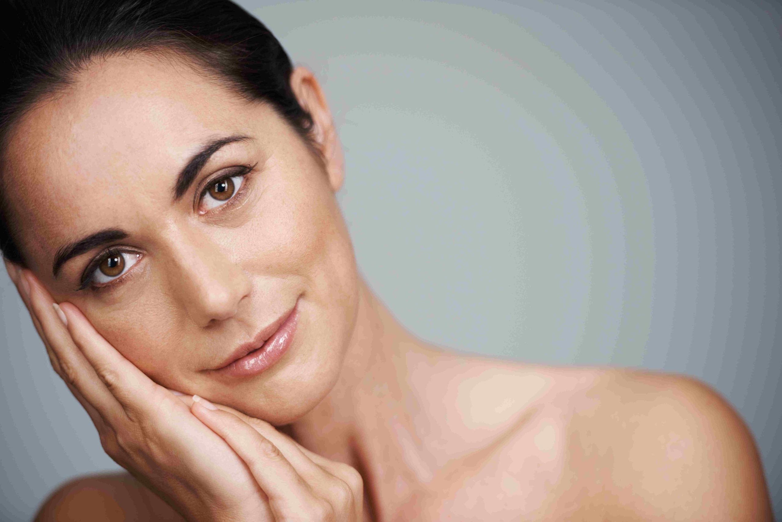 Woman Touching her Cheeks with Hands | Avail Aesthetics in Wake Forest, NC
